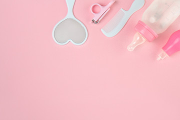 Newborn child care. Hygiene accessories, and bath set on pink background.