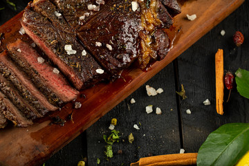 Sliced meat barbecue served with sea salt and oregano leaves