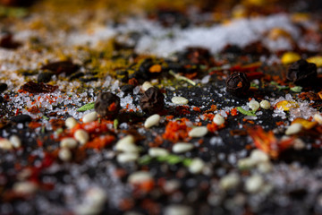 Variety of spices and herbs on black background