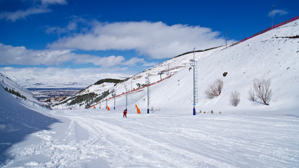 Fototapeta na wymiar ERZURUM, TURKEY - FEBRUARY 28, 2020: Palandöken mountain ski resort. Skiing and snowboarding tourists. Young people doing ice climbing.