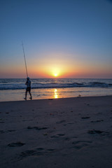 Fototapeta na wymiar fishing at sunset