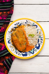 Mexican chili-stuffed poblano with rice on white background