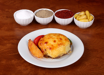 very nice hasanpasa patties with mashed potatoes, mashed peppers, white plate on the wooden table, together with the fragrant turkish spice