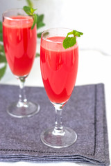 Watermelon or strawberry mojito drink with mint. Grey napkin background. Selective focus.