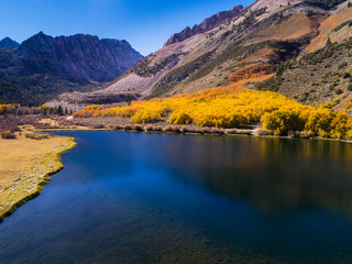 Naklejka premium Aerial view of North Lake with reflections of fall aspen and mountains .