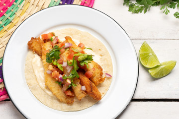 Mexican breaded fish tacos also called ensenada on white background