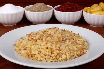 Delicious cooked buckwheat ready to serve on a plate with various Turkish spices