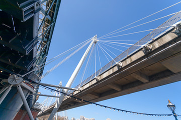 A below view of the foot bridge and the railway in the Hungerford Bridge, London.