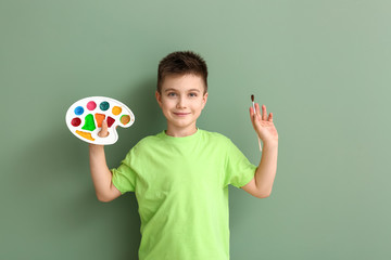 Cute little artist on color background