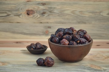 dried dates palm fruit on a old wooden table.