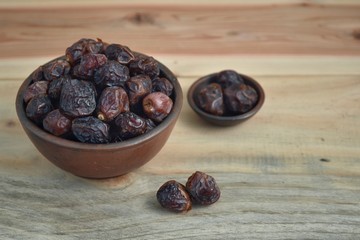 dried dates palm fruit on a old wooden table.