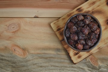 dried dates palm fruit on a old wooden table.