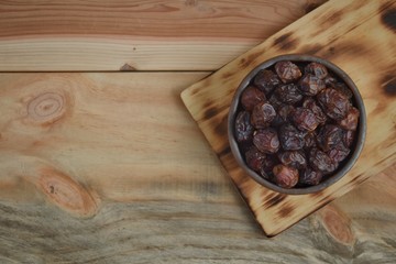 dried dates palm fruit on a old wooden table.