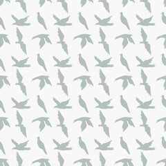 Grey silhhouettes of birds on white background: seamless pattern, light wallpaper design, textile print. Vector graphics.