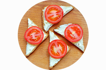 Бутерброды с помидором и майонезом на разделочной доске