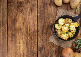 Fried Potatoes on a wooden table (selective focus)
