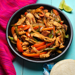 Mexican chicken fajitas on turquoise background