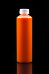 yellow-orange smoothie in a bottle, take concept on black background