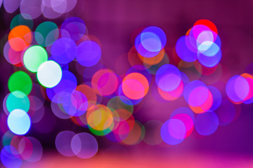 Bokeh colorful multi-colored lights yellow red blue green. Blurry lights Christmas mood. Lights from Christmas garlands defocused in beautiful bokeh. Copy space on background of multi-colored.