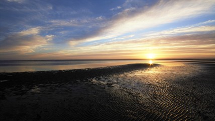 Paisaje con baja mar y atardecer