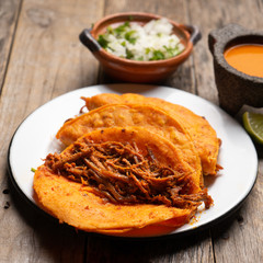 Mexican beef  birria tacos on wooden background