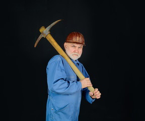 Construction worker holds pickaxe. Man contractor with axe. Smiling workman with pickaxe....