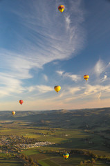Hot Air Balloons Flying Over Landscape