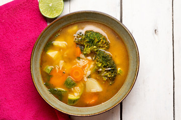 Vegetables soup with rice on white background