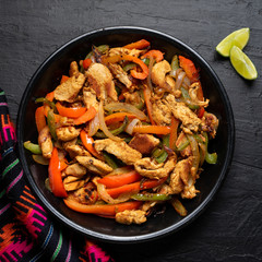 Mexican chicken fajitas on dark background