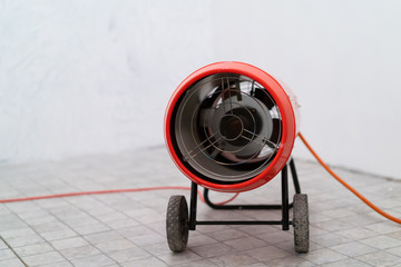 Gas heat gun. Equipment for suspended ceilings. Red tank of propane and a gun. Isolated on a white...