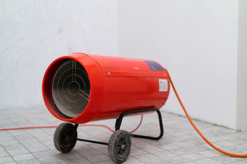 Gas heat gun. Equipment for suspended ceilings. Red tank of propane and a gun. Isolated on a white...