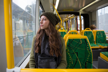 Fototapeta na wymiar Young Woman Sitting Alone on Melbourne Tram