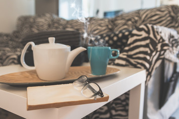 cup of tea and book on the coffee table