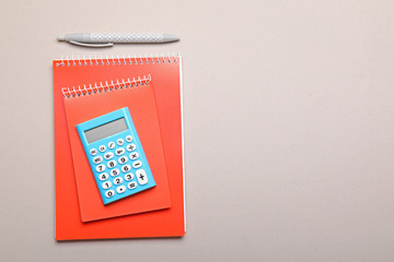 Modern calculator with stationery on grey background