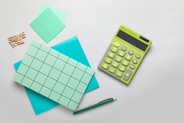 Modern calculator with stationery on light background