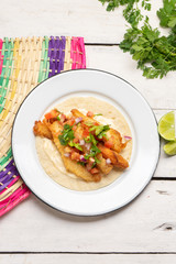 Mexican breaded fish tacos also called ensenada on white background