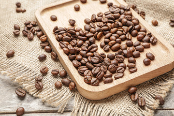 Plate with coffee beans on table
