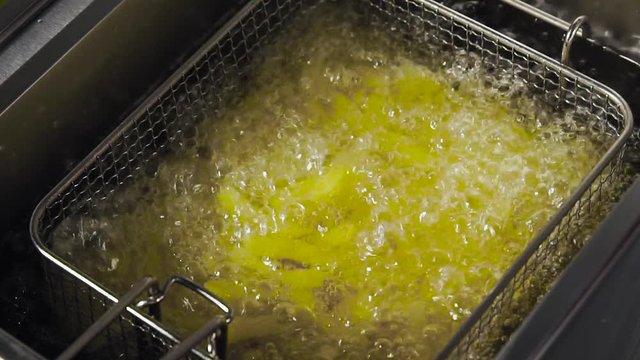 Process of cooking French fries in the deep fryer