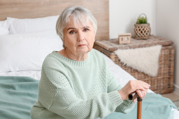 Elderly woman suffering from mental disability at home