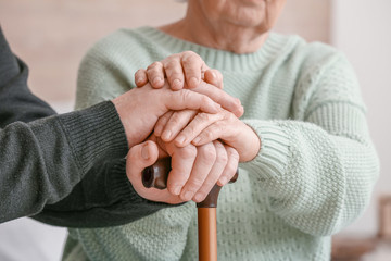 Elderly people suffering from mental disability at home, closeup