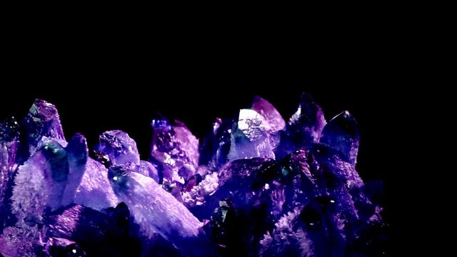 Amazing colorful Quartz Purple crystal cluster isolated on black background, Angel aura mineral. Macro of beautiful raw mineral stone