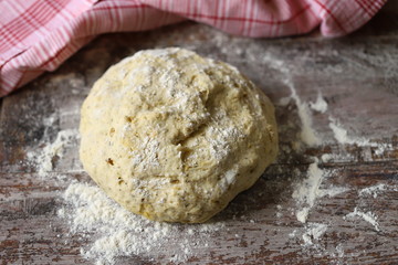 Selective focus. Macro. Fresh homemade yeast dough, olives and spices for making focaccia with Italian herbs. Cooking at home. Traditional italian bread.