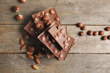 Sweet chocolate with nuts on wooden table