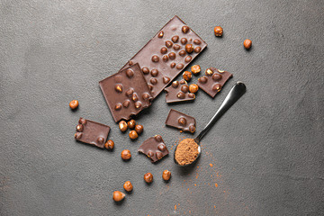 Sweet chocolate with nuts on dark background
