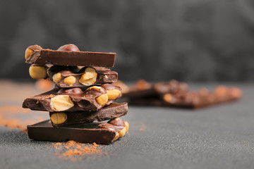 Sweet chocolate with nuts on dark background