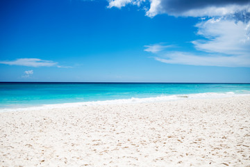 Fototapeta na wymiar white sand beach with blue sky