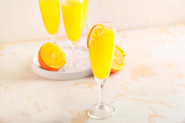 Glass of tasty mimosa cocktail on white table