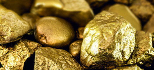 gold stones, rough gold nuggets on black background.