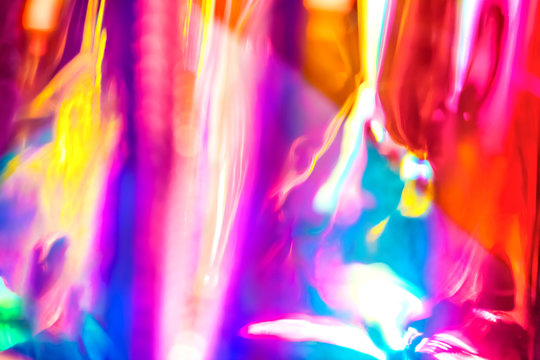 Abstract vivid wallpaper of holographic vertical lens flare neon lights with spectrum psychedelic saturated neon colors and shiny glowing reflections