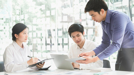 Asian business adviser meeting to analyze and discuss the situation on the financial report in the meeting room.Investment Consultant,Financial Consultant,Financial advisor and accounting concept